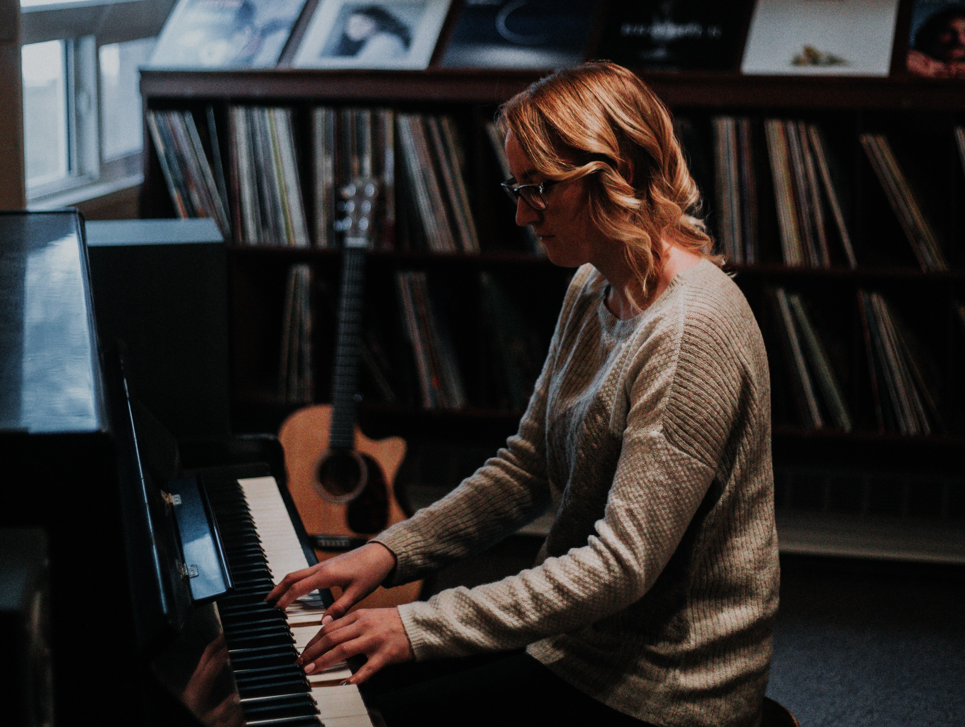 Woman playing piano in music room after school